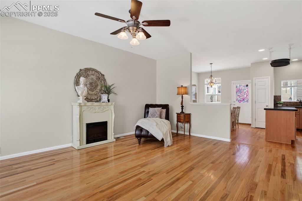 Image 7 of 36: Spacious and bright living room with hardwood flooring!