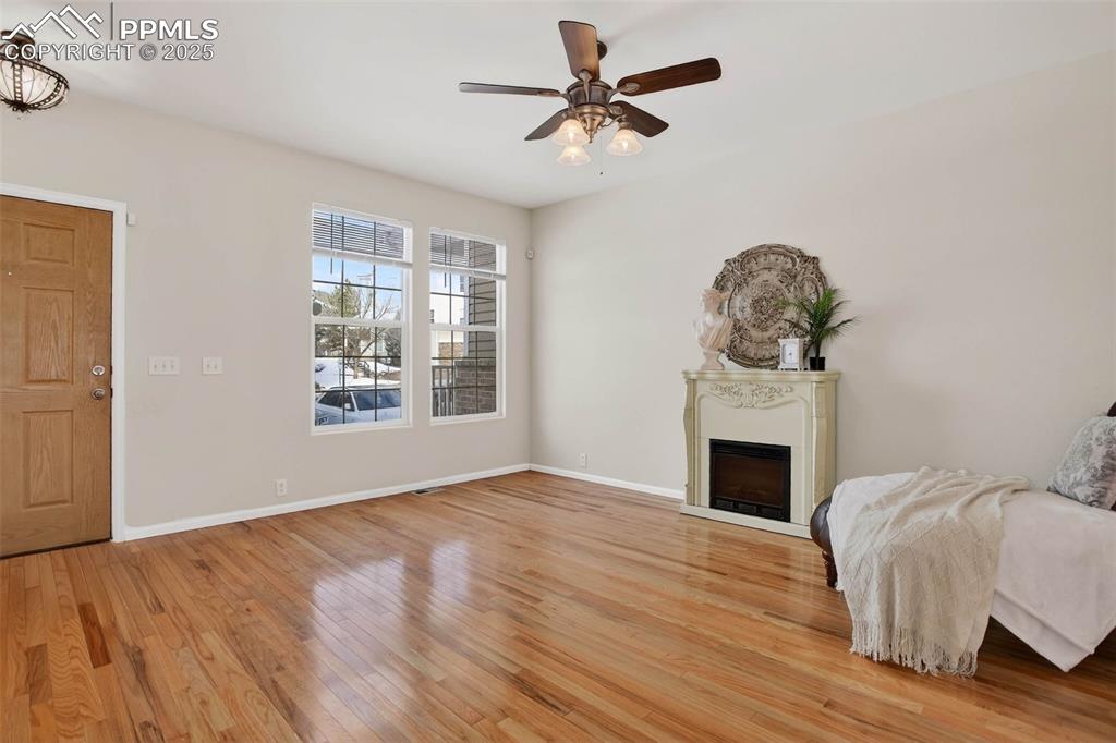 Image 8 of 36: Spacious and bright living room with hardwood flooring!