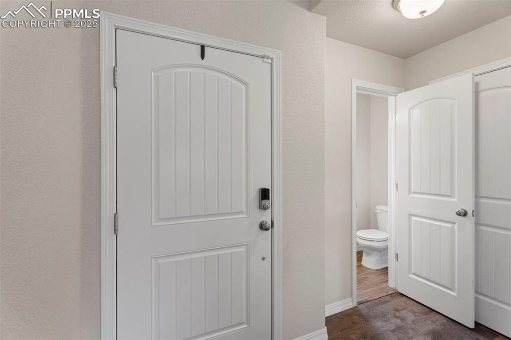 Image 9 of 26: Entry and main level powder room entrance.