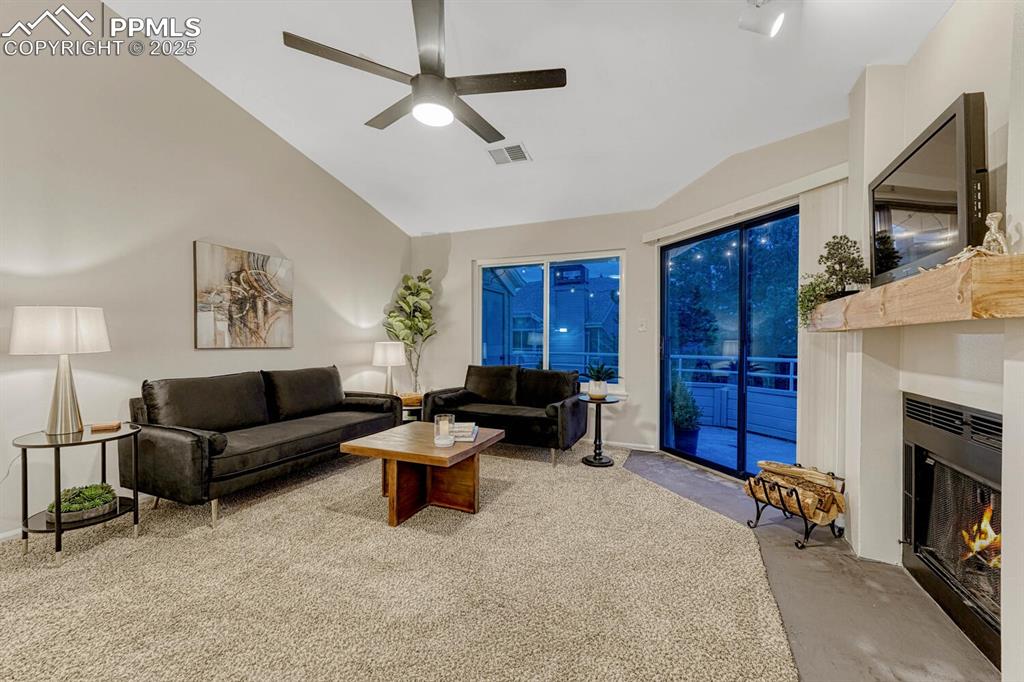 Image 3 of 50: Living room walks out to a large private deck