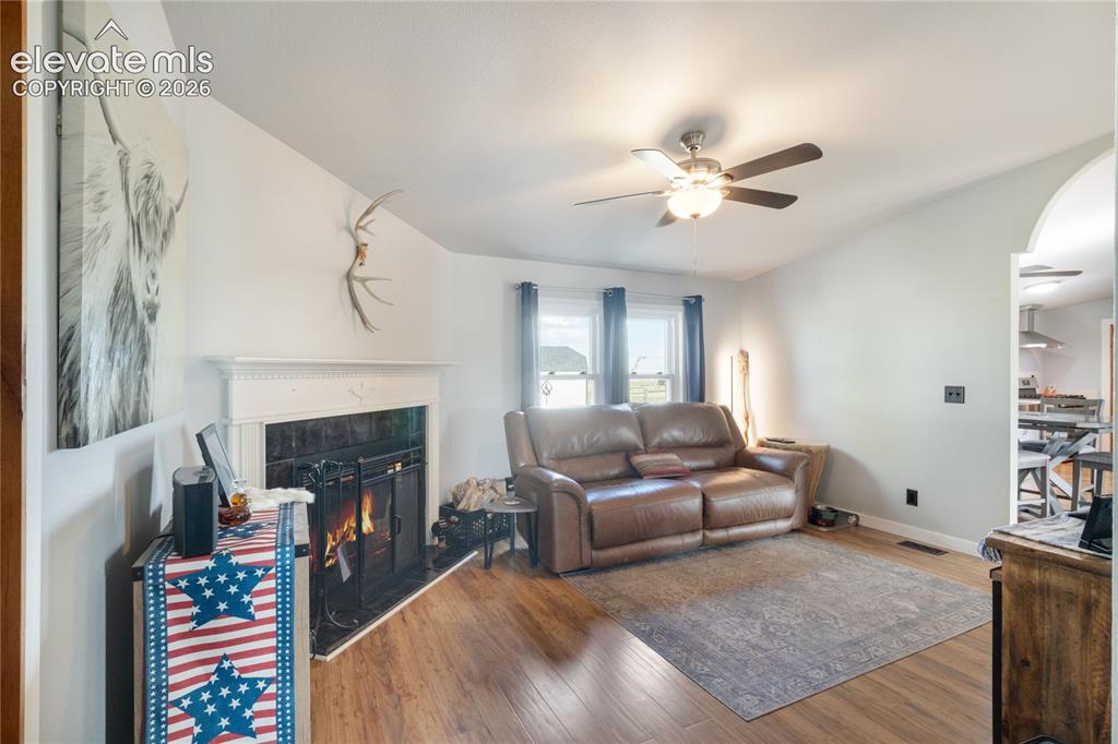 Image 11 of 36: Family Room with fireplace and large windows looking into the backyard. Coz