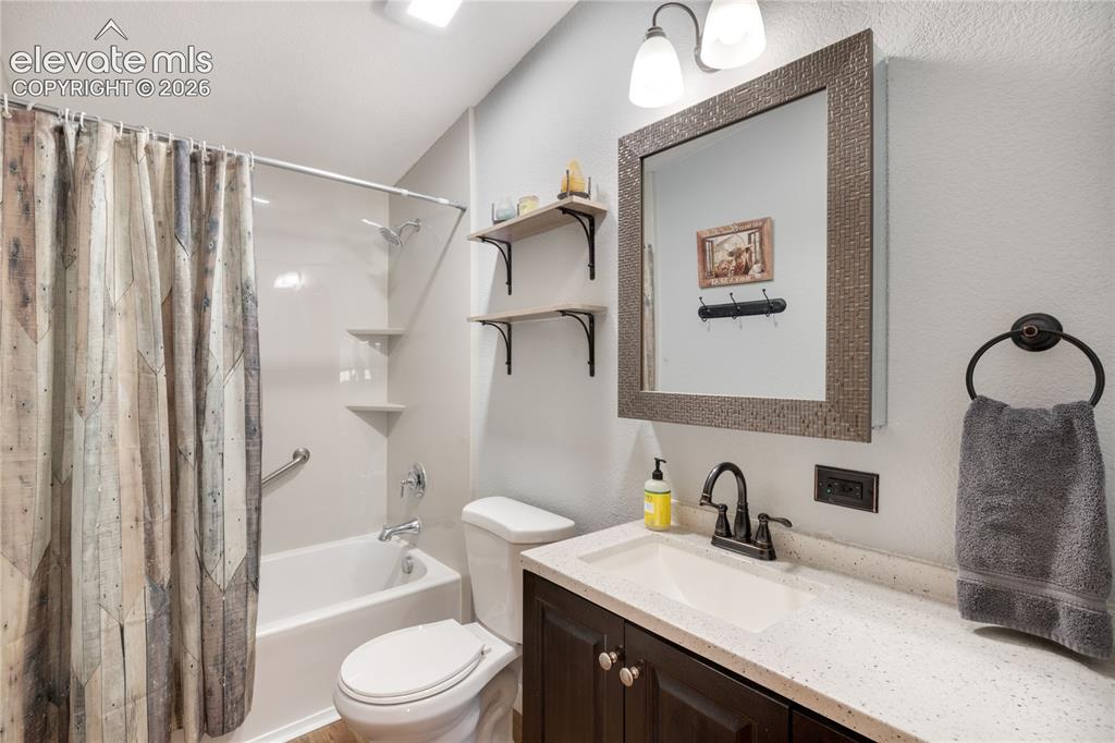 Image 29 of 36: Updated hall bathroom shared by the three bedrooms