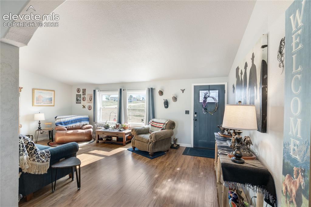 Image 3 of 36: Living Room and entry, large window looking into the front yard.