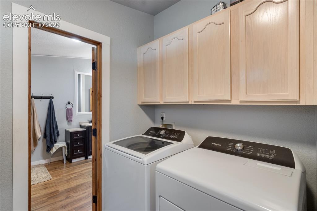 Image 30 of 36: Laundry Space with a door to the backyard, between the Primary Bathroom and