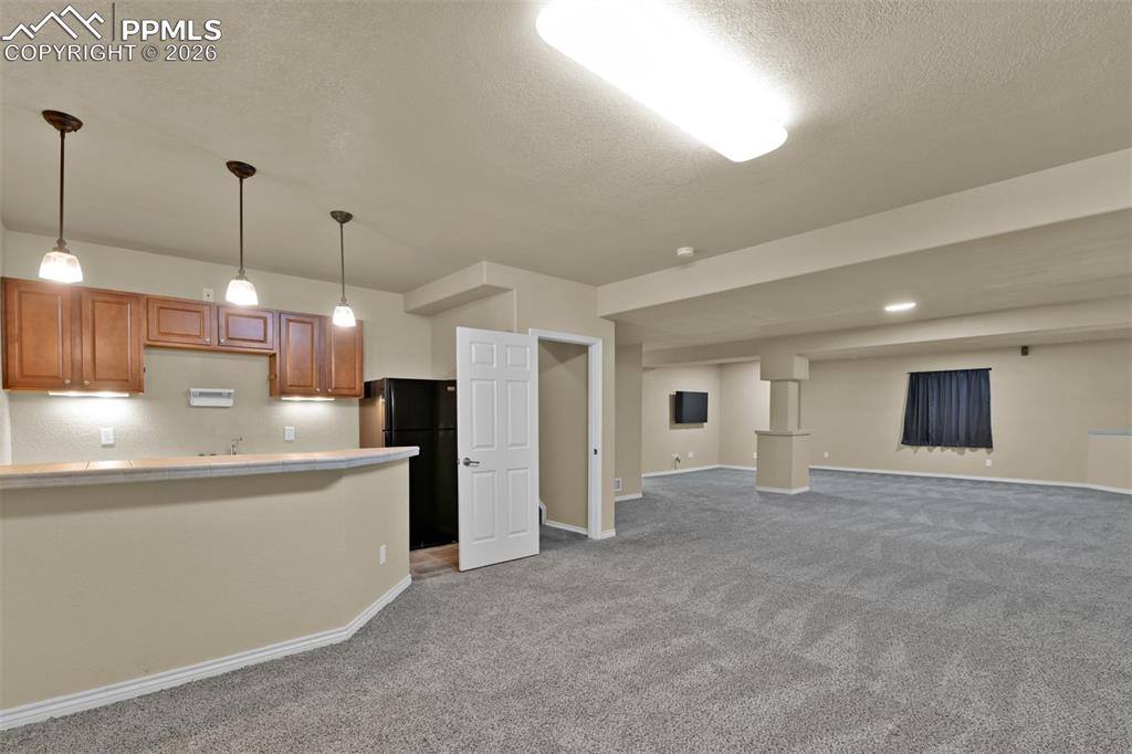 Image 30 of 50: Basement family room with wetbar