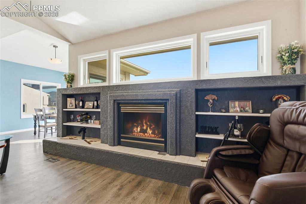 Image 18 of 47: Living area featuring a fireplace and built in shelves