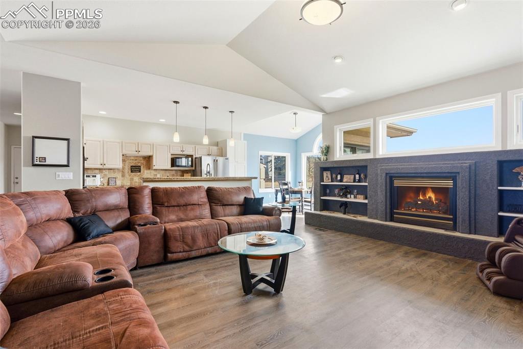 Image 20 of 47: Living area with a fireplace, and built in shelving