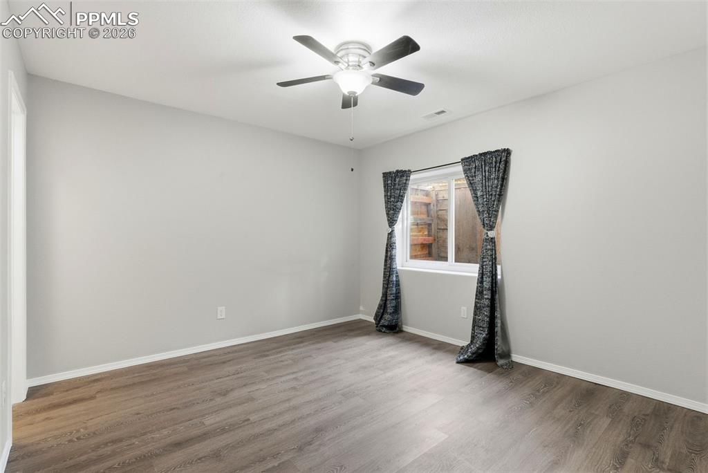 Image 43 of 47: Bedroom with walk in closet and a ceiling fan