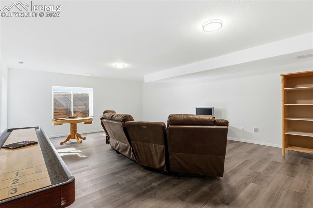 Image 46 of 47: Family room with grey plank floors