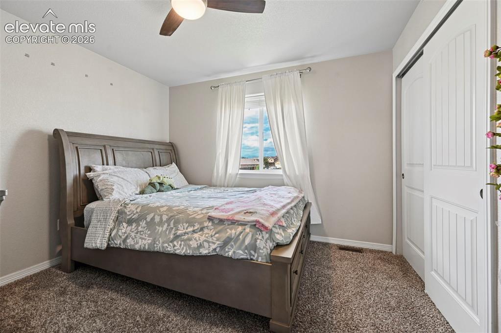 Image 17 of 29: Carpeted flooring, window with natural light, ceiling fan with integrated l