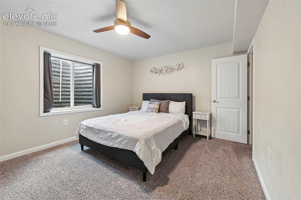 Image 18 of 29: Neutral wall paint, ceiling fan with integrated lighting, window with windo