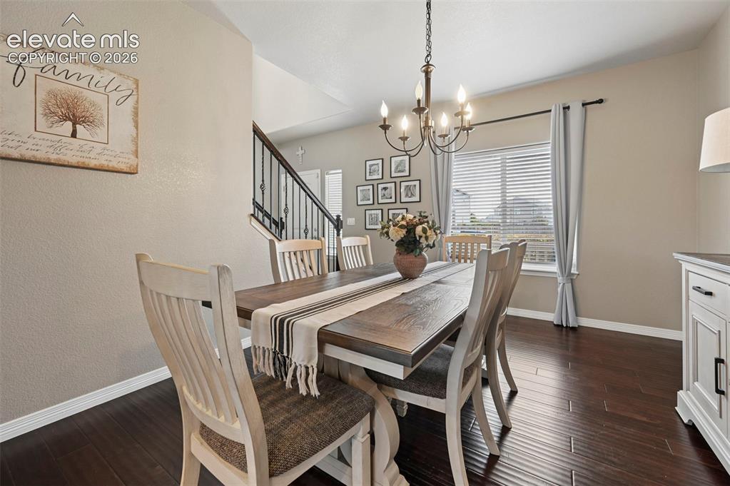 Image 2 of 29: Rich wood-finish flooring complements neutral wall tones