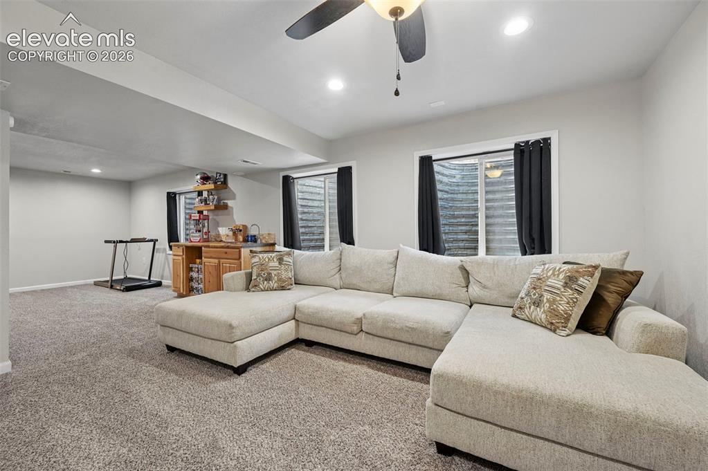 Image 20 of 29: Recessed lighting, a ceiling fan, and carpeted flooring