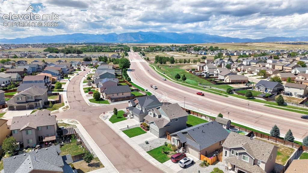 Image 27 of 29: Residential neighborhood with varied architectural styles, mature landscapi