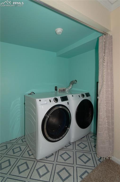 Image 11 of 23: Laundry room with washer and clothes dryer