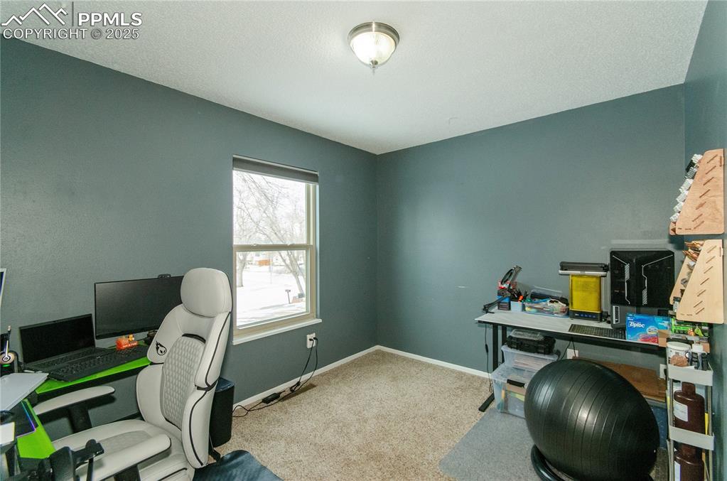 Image 17 of 23: bedroom currently used as home office