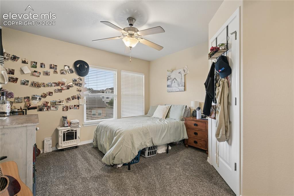 Image 10 of 28: Neutral-toned room featuring a ceiling fan with integrated lighting, two wi
