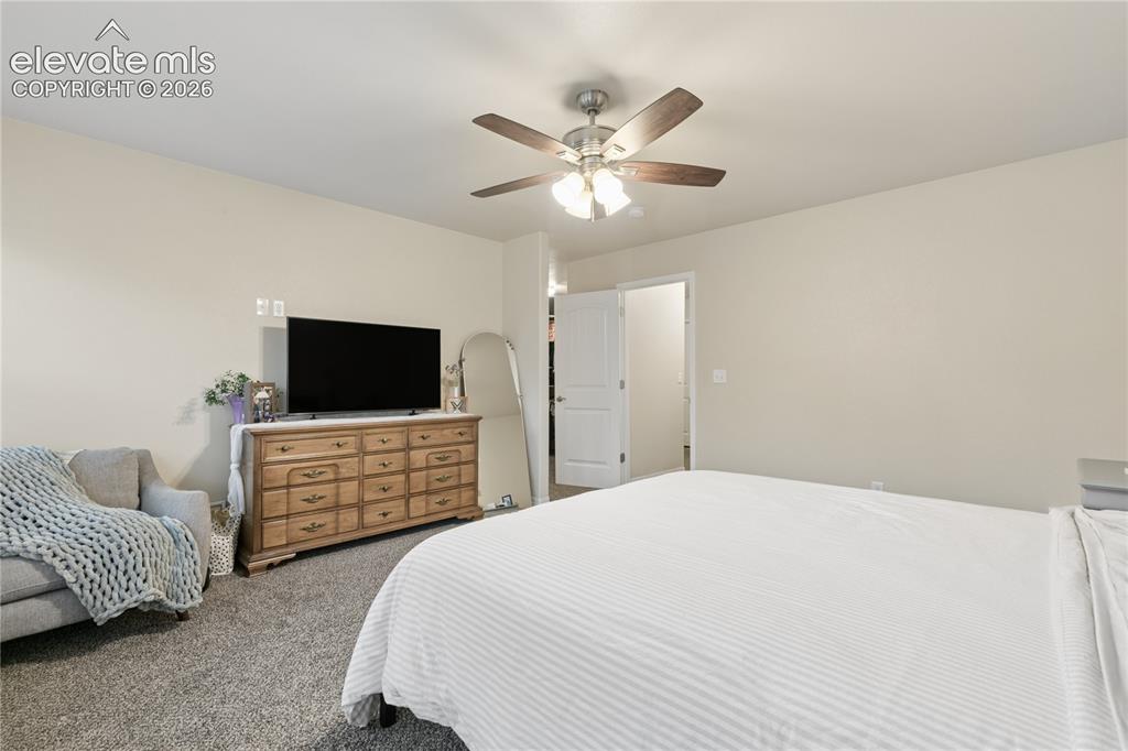 Image 13 of 28: Wall-to-wall carpeting and a ceiling fan with integrated lighting