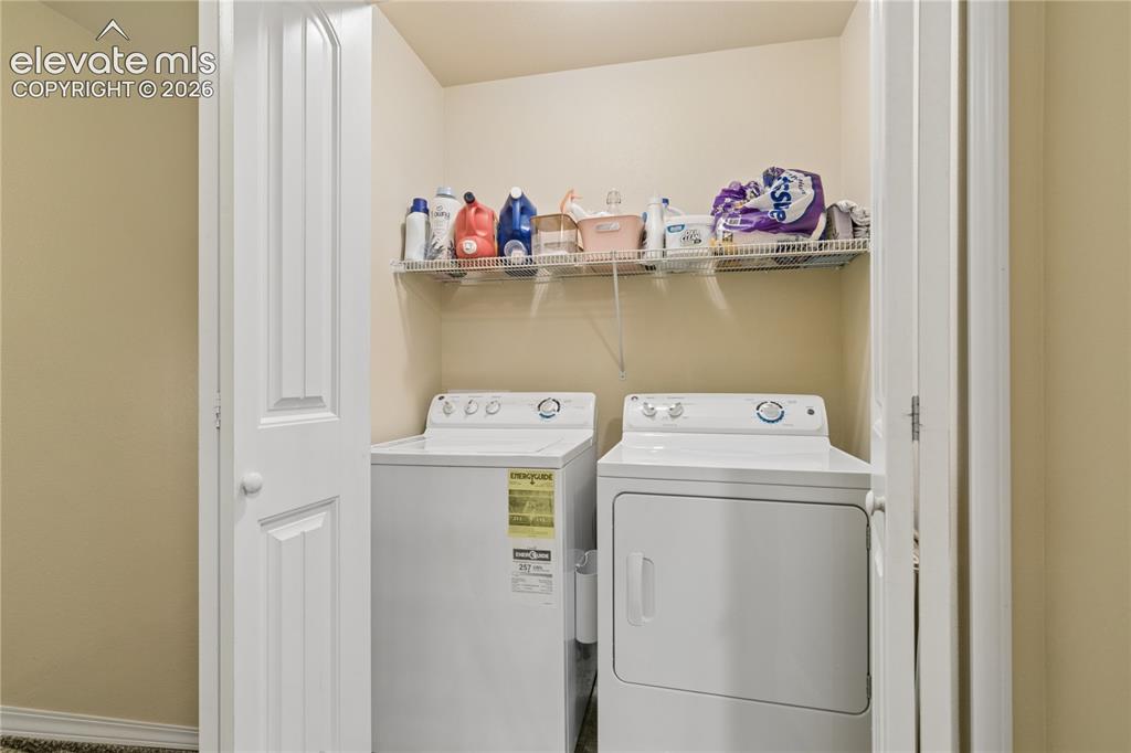 Image 15 of 28: Dedicated laundry area featuring a white top-load washer, a white front-loa