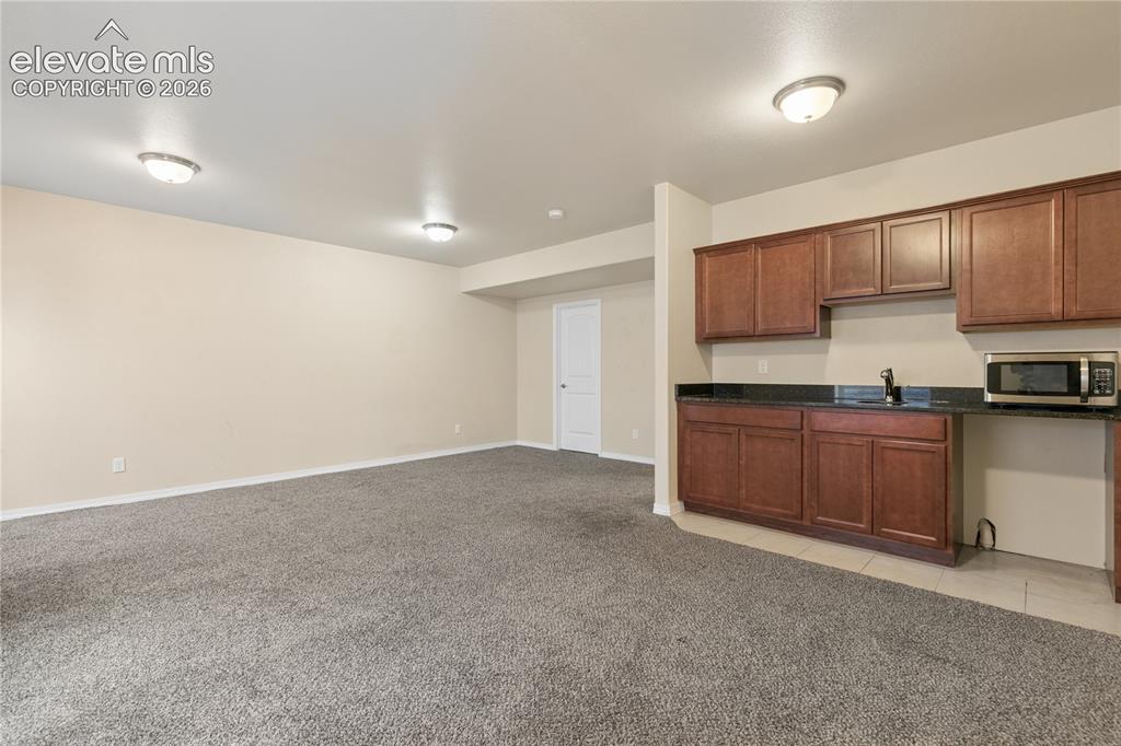 Image 23 of 28: Spacious room featuring neutral carpeting and flush-mount lighting