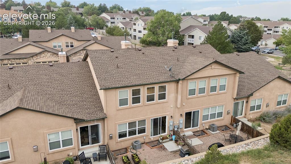 Image 28 of 28: Rear exterior featuring stucco finish, multiple sliding glass doors, upper-
