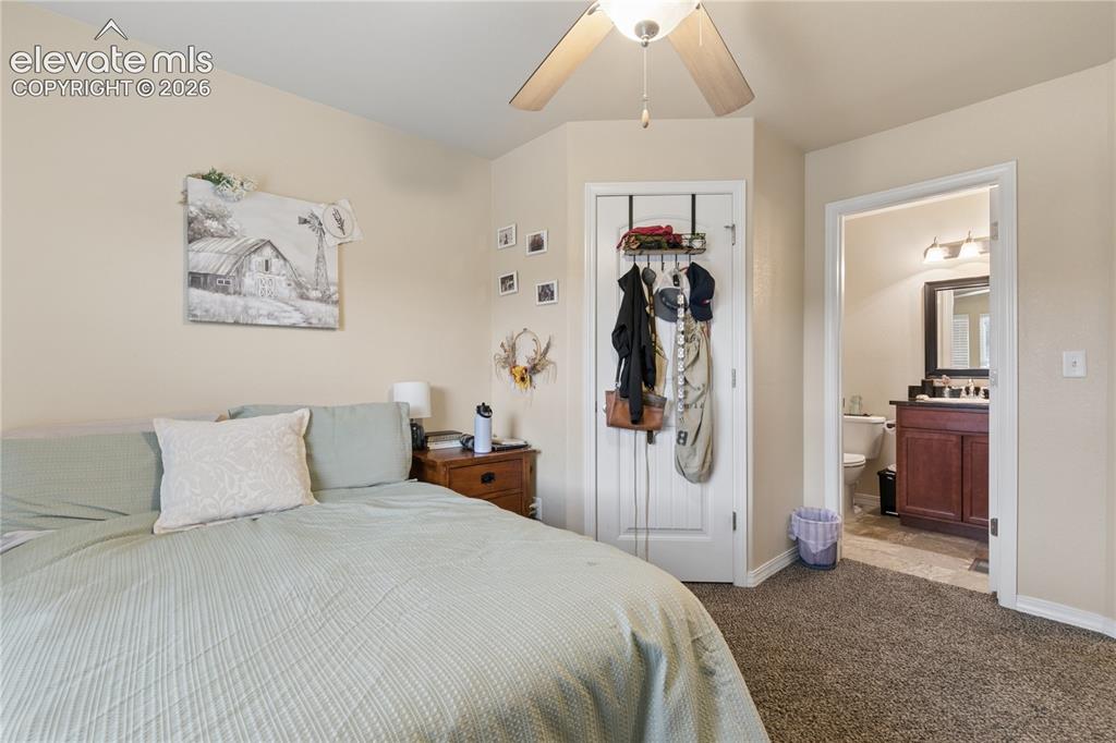Image 9 of 28: Carpeted room with neutral wall tones and a ceiling fan