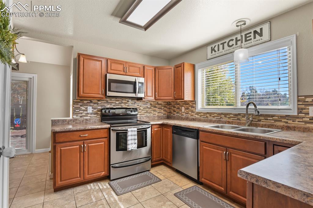 Image 13 of 50: Stainless Appliances and tile floors