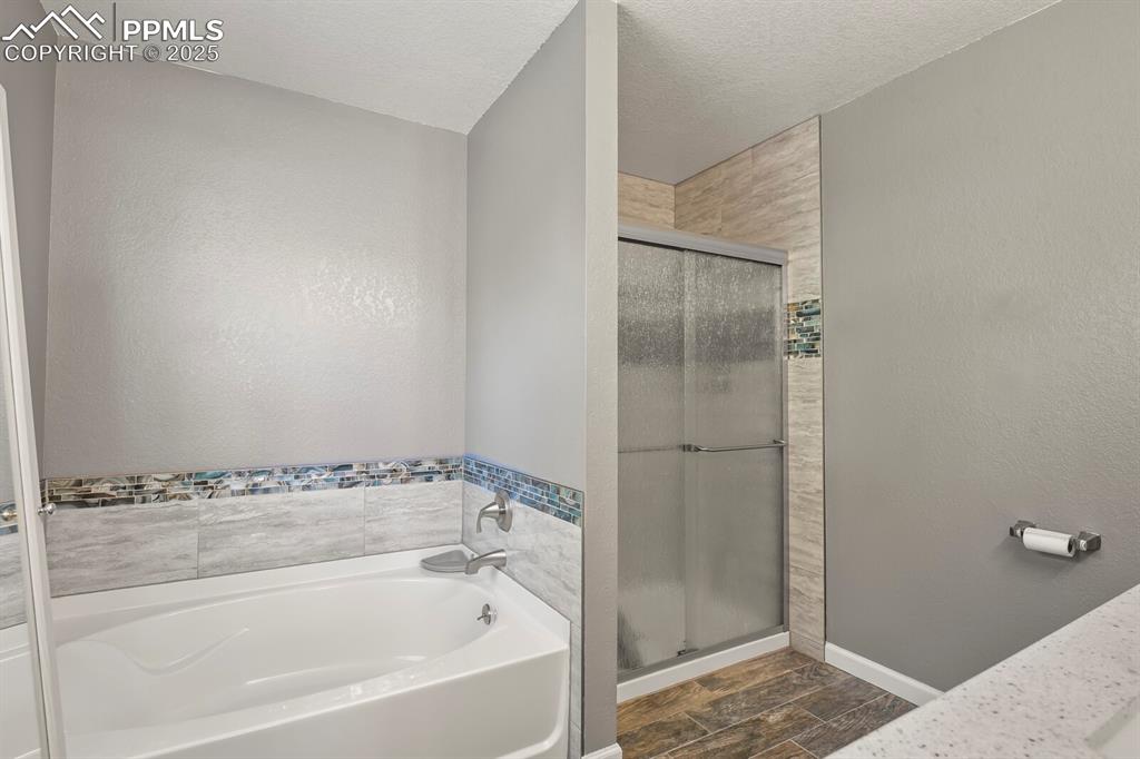 Image 31 of 50: Soaking Tub and Separate Shower in Updated Primary Bathroom