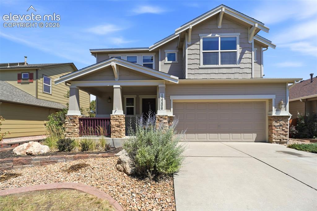 Image 1 of 47: Craftsman-style exterior featuring a covered front porch with stone-clad co