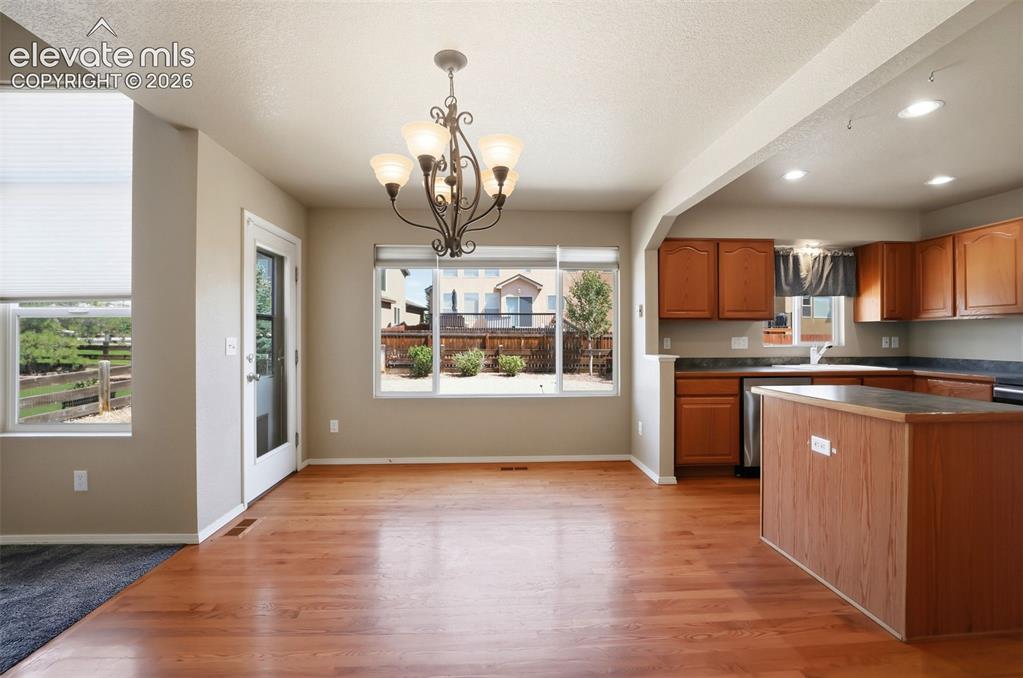 Image 13 of 47: Open-concept kitchen | dining space with a walk out to the backyard