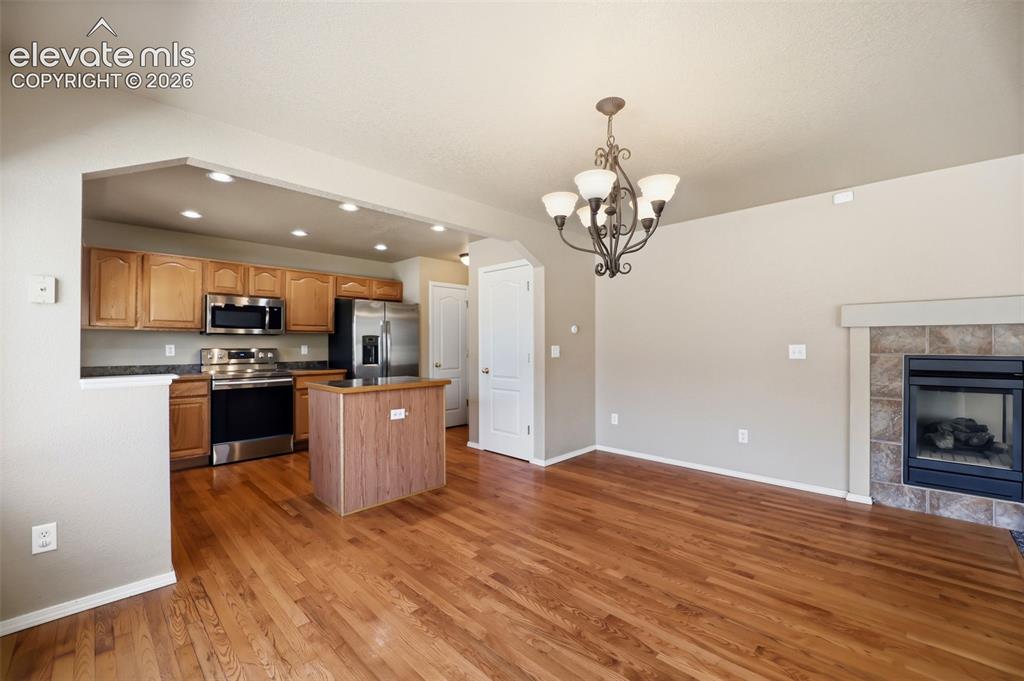 Image 14 of 47: Open concept living area with wood flooring