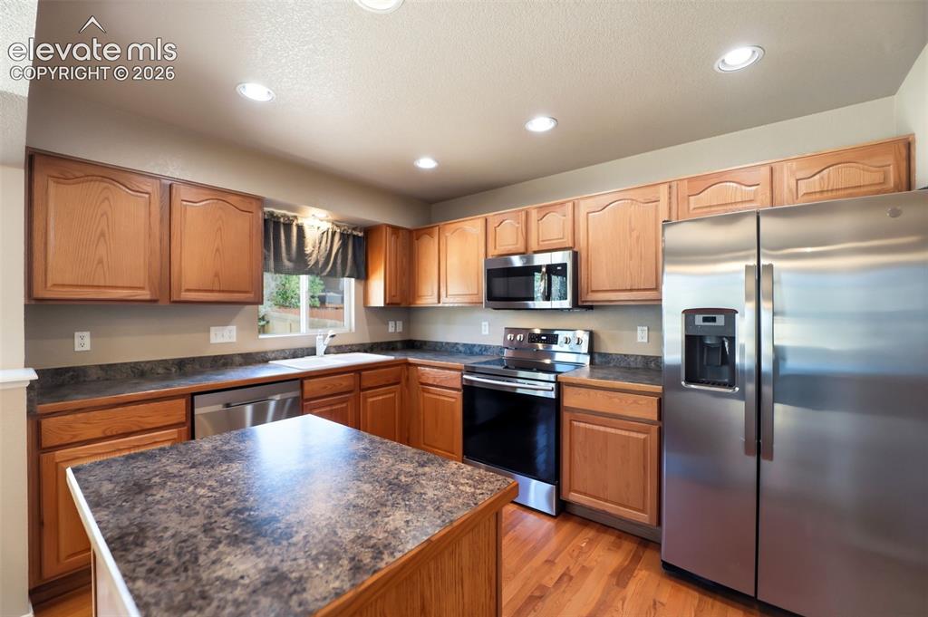 Image 15 of 47: Kitchen featuring wood cabinetry, stainless steel appliances, recessed ligh