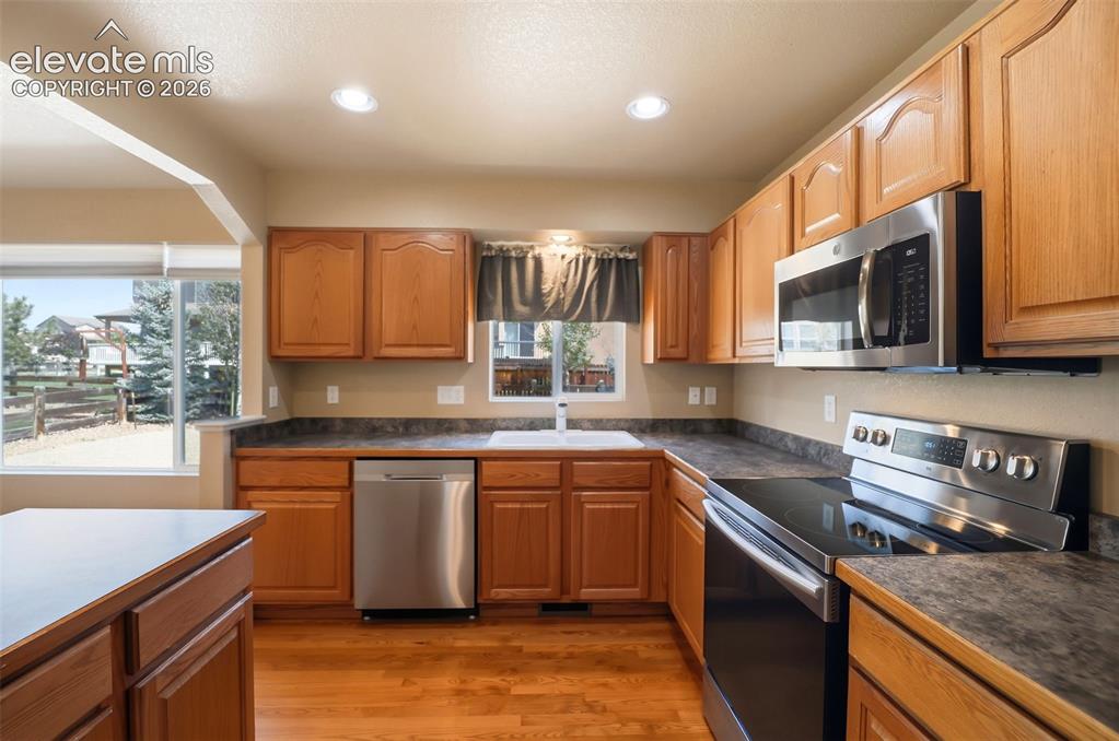 Image 16 of 47: Kitchen featuring wood-finish cabinetry, stainless steel appliances, and a