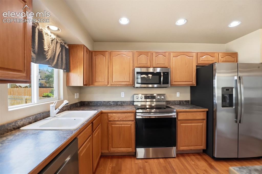 Image 17 of 47: Kitchen featuring wood cabinetry, stainless steel appliances, recessed ligh