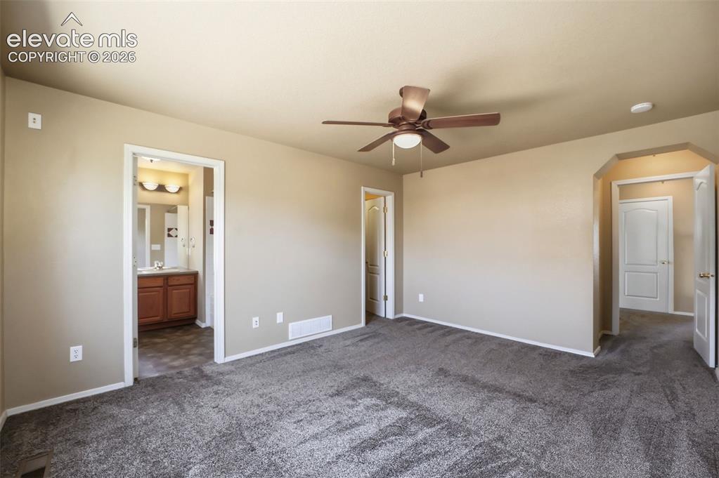Image 23 of 47: Spacious room featuring neutral carpeting, a ceiling fan with integrated li