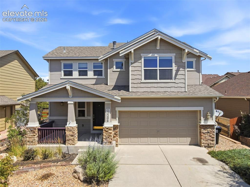 Image 38 of 47: Contemporary two-story residence featuring a covered front porch with stone