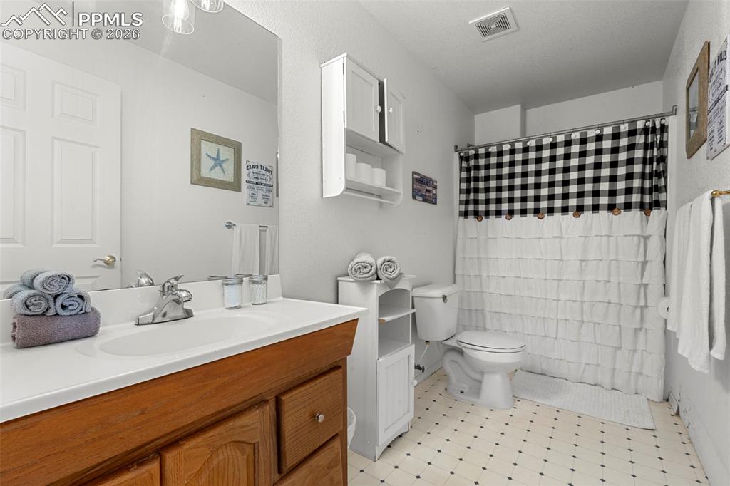 Image 22 of 35: Bathroom featuring vanity, a shower with shower curtain, and light flooring