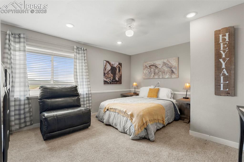 Image 25 of 35: Bedroom with light colored carpet, a ceiling fan, and recessed lighting
