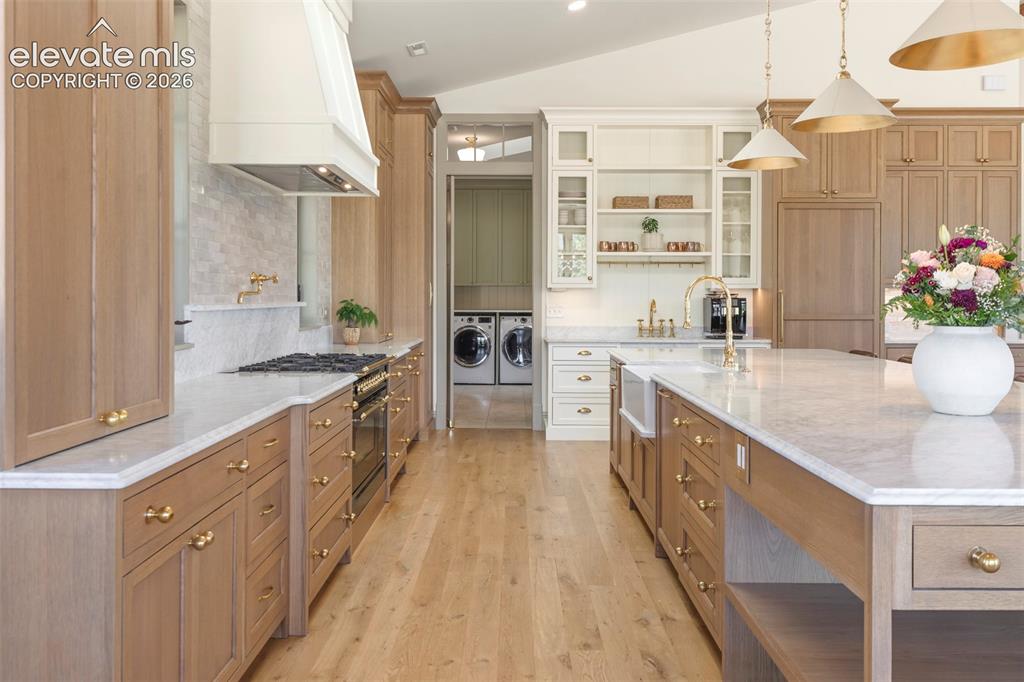 Image 11 of 49: Integrated appliances, an ILVE professional range, solid unlacquered brass