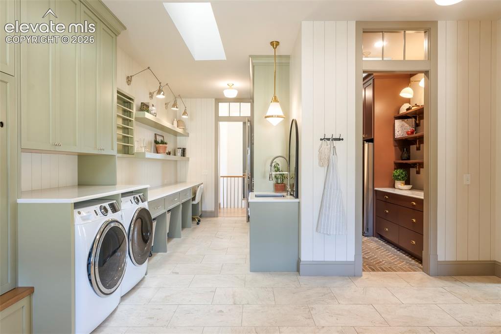 Image 17 of 49: Integrated rolling laundry storage, generous folding station, designer task