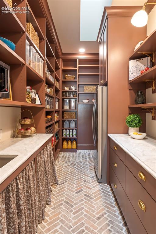 Image 18 of 49: Custom floor to celing cabinetry provides exceptional storage, marble count