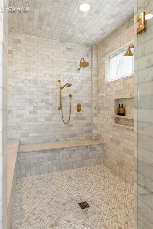 Image 24 of 49: Walk - in shower, featuring a large two person soaking tub within the large