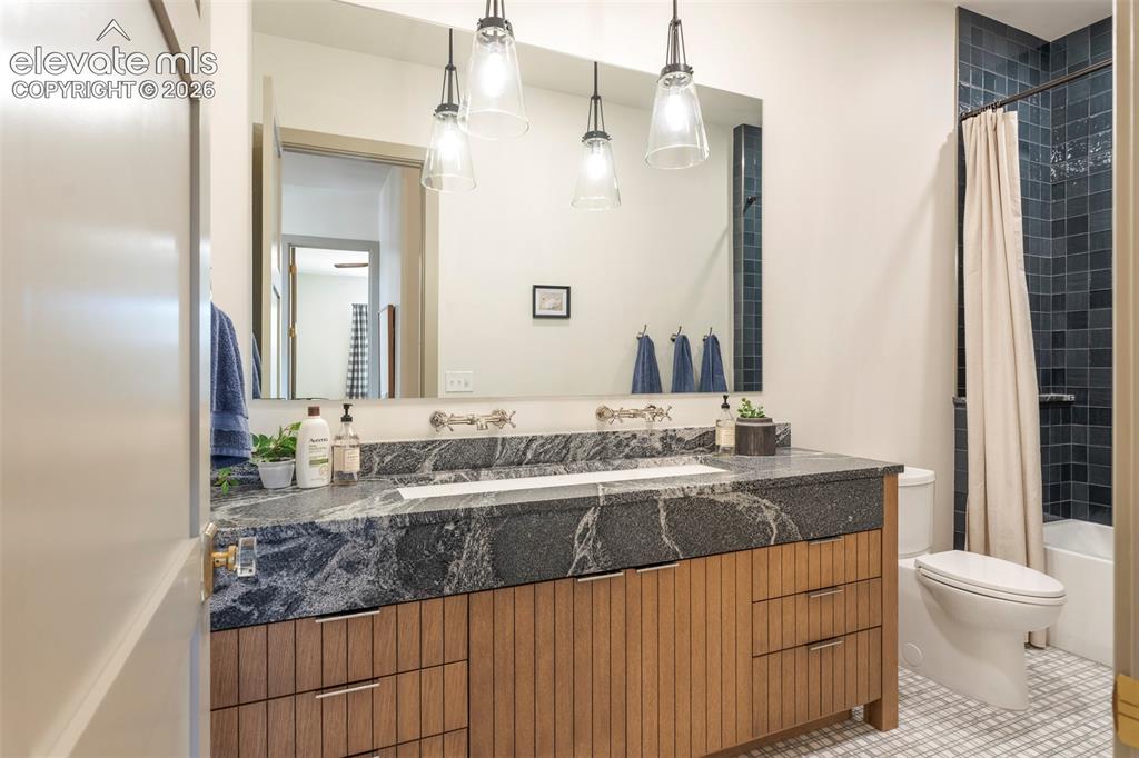 Image 28 of 49: Stylish secondary bathroom with modern vanity and upgraded finishes.