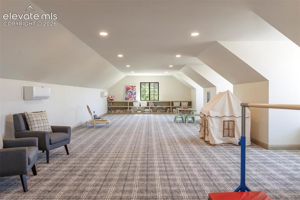 Image 31 of 49: Perched above the garage, the expansive loft is a light - filled haven desi