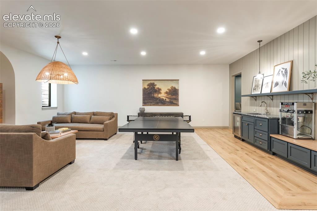 Image 32 of 49: Lower level lounge offers a warm and inviting setting for gatherin, enterta