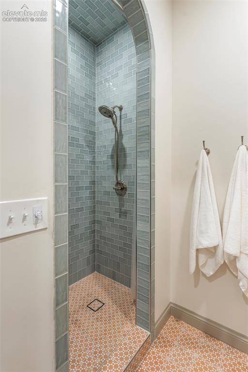Image 38 of 49: Artisan tile, graceful arched entry and terra cotta - inspired til floor.