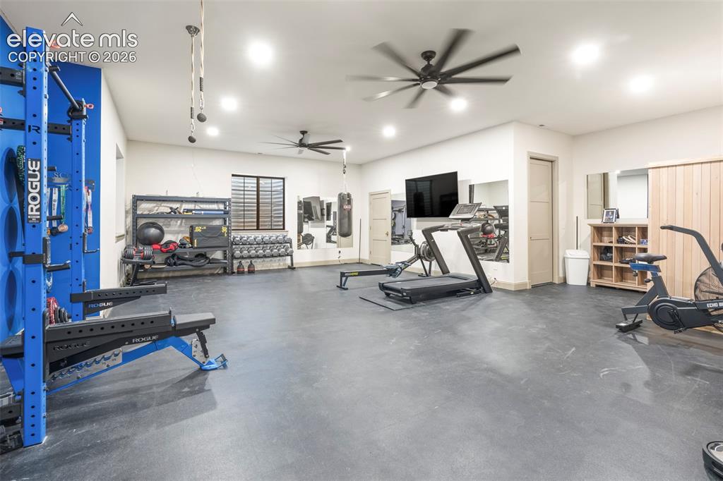 Image 43 of 49: Private wellness studio, expansive fitness room, rubber flooring, drinking