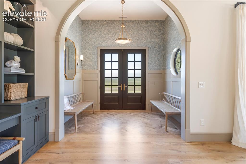 Image 5 of 49: Exquisite designer wallpaper, custom millwork surround and framed by a larg