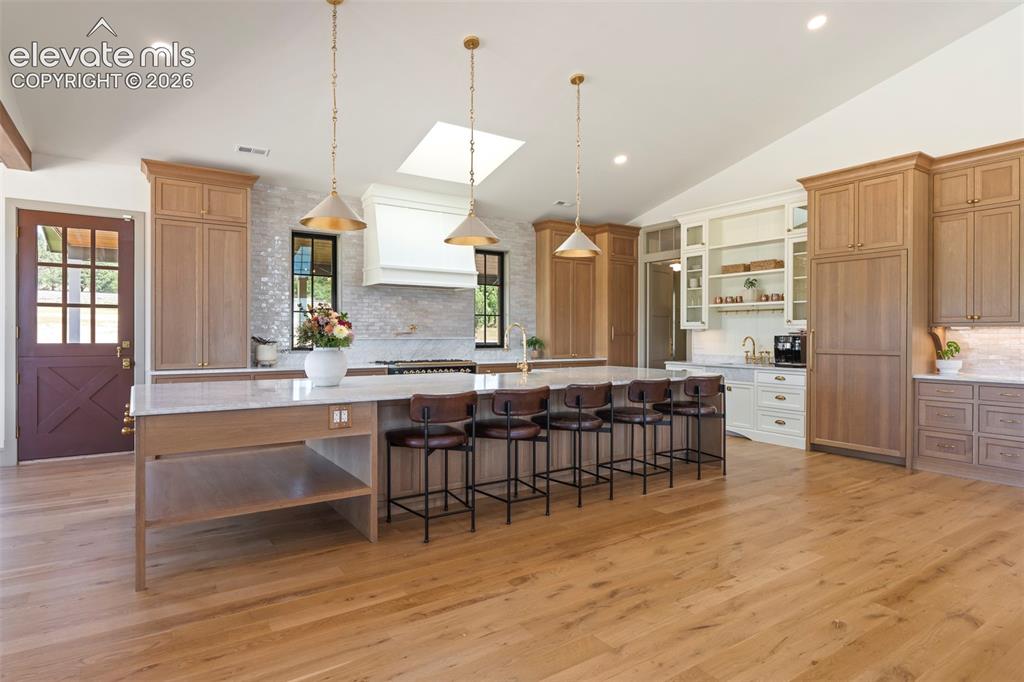 Image 9 of 49: Hand crafted Zellige tile, integrated appliances and concealed storage thro