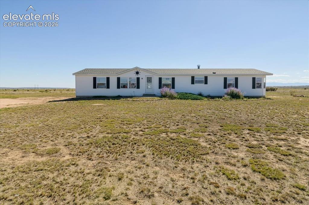 Image 1 of 25: Single-story residence with a white exterior and black window shutters
